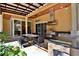 Outdoor kitchen with grill and seating area under a covered patio at 695 Se 47Th Loop, Ocala, FL 34480