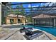 Luxurious swimming pool with lounge chairs and a covered bar area at 695 Se 47Th Loop, Ocala, FL 34480