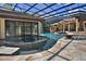 Resort style screened-in pool featuring spa, waterfall, water slide, lush gardens and sunning space at 695 Se 47Th Loop, Ocala, FL 34480