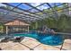 Stunning outdoor pool with grotto and swim-up bar, perfect for entertaining and relaxation at 695 Se 47Th Loop, Ocala, FL 34480