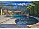 Inviting screened-in pool area with a slide, waterfall feature, and a charming cabana for ultimate relaxation at 695 Se 47Th Loop, Ocala, FL 34480