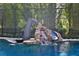 Exciting pool area featuring a slide surrounded by lush greenery at 695 Se 47Th Loop, Ocala, FL 34480