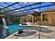 Screened in outdoor living space with large pool, water slide, fountains and summer kitchen at 695 Se 47Th Loop, Ocala, FL 34480