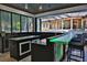 Outdoor bar area with granite countertops, seating, and views of the pool, water slide, and backyard at 695 Se 47Th Loop, Ocala, FL 34480