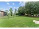 Spacious backyard with lush green grass and a secure black fence, perfect for outdoor activities and relaxation at 7839 Sw 97Th Cir, Ocala, FL 34481