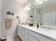 Bright bathroom featuring double sinks, granite countertops, white cabinetry, and modern fixtures at 7839 Sw 97Th Cir, Ocala, FL 34481