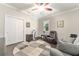 Cozy bedroom featuring a ceiling fan, a sitting area, and neutral paint colors at 7839 Sw 97Th Cir, Ocala, FL 34481