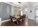 Cozy dining room featuring a table with seating for six, complemented by stylish wall art and lighting at 7839 Sw 97Th Cir, Ocala, FL 34481