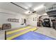 Well-lit two-car garage with ample storage space, featuring an organized layout for vehicles and equipment at 7839 Sw 97Th Cir, Ocala, FL 34481