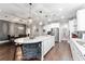 Open kitchen with a large island featuring stone accents and modern pendant lighting at 7839 Sw 97Th Cir, Ocala, FL 34481
