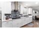 Stylish kitchen featuring white cabinets, granite counters, and stainless steel appliances at 7839 Sw 97Th Cir, Ocala, FL 34481