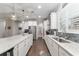 Modern kitchen features white cabinets, stainless steel appliances, and granite countertops at 7839 Sw 97Th Cir, Ocala, FL 34481