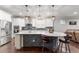Open kitchen featuring a large island with bar seating, stainless steel appliances, and white cabinetry at 7839 Sw 97Th Cir, Ocala, FL 34481