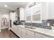 Well-lit kitchen with sleek countertops, stainless steel appliances, and stylish backsplash at 7839 Sw 97Th Cir, Ocala, FL 34481