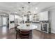 Bright kitchen with a large round island, stainless steel appliances, and dark wood floors at 7839 Sw 97Th Cir, Ocala, FL 34481