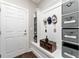 Organized mudroom with storage bins, coat hooks, a bench, and a decorative trunk near the door at 7839 Sw 97Th Cir, Ocala, FL 34481