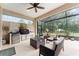 Outdoor kitchen area, complete with stone accents, a grill, and comfortable seating for outdoor entertaining at 7839 Sw 97Th Cir, Ocala, FL 34481