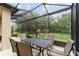 Covered patio offering a dark outdoor dining set, ideal for enjoying meals and relaxing in the backyard at 7839 Sw 97Th Cir, Ocala, FL 34481