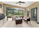 Relaxing screened patio with cushioned seating and an outdoor grill, perfect for entertaining guests at 7839 Sw 97Th Cir, Ocala, FL 34481