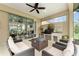 Inviting screened patio featuring a stone outdoor kitchen and seamless transition to indoor living space at 7839 Sw 97Th Cir, Ocala, FL 34481