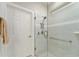 Modern bathroom with a sleek glass-enclosed shower featuring tiled walls and a convenient grab bar at 7839 Sw 97Th Cir, Ocala, FL 34481