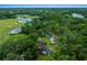 Aerial view of the home highlighting the golf course, water features, and mature trees at 7961 Midway Drive Ter # J102, Ocala, FL 34472
