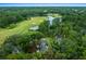 Picturesque aerial shot highlighting serene lake and golf course views surrounding a beautiful home at 7961 Midway Drive Ter # J102, Ocala, FL 34472