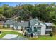 Aerial view of the home highlighting the mature trees, roofline, and private setting at 7961 Midway Drive Ter # J102, Ocala, FL 34472