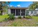 Well-maintained backyard with lush landscaping and a screened-in porch that is perfect for relaxing at 7961 Midway Drive Ter # J102, Ocala, FL 34472