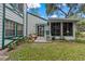 Backyard patio area with a comfortable seating that overlooks the lawn and mature trees at 7961 Midway Drive Ter # J102, Ocala, FL 34472