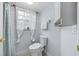 Bathroom featuring a toilet, a shower behind a curtain, and a window at 7961 Midway Drive Ter # J102, Ocala, FL 34472