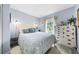Bright bedroom with stylish decor, comfortable bed, and natural light from the window at 7961 Midway Drive Ter # J102, Ocala, FL 34472