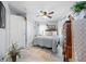 Cozy bedroom with hardwood floors, closet, ceiling fan, dresser, and area rug at 7961 Midway Drive Ter # J102, Ocala, FL 34472