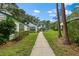 Charming home exterior with lush greenery and a well-maintained lawn on a sunny day at 7961 Midway Drive Ter # J102, Ocala, FL 34472