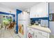 Functional kitchen with white cabinets and appliances, adjacent to a dining area, offers a convenient layout at 7961 Midway Drive Ter # J102, Ocala, FL 34472