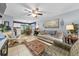 Inviting living room with a ceiling fan, tile flooring, and comfortable seating that create a cozy ambiance at 7961 Midway Drive Ter # J102, Ocala, FL 34472