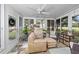 Relaxing sunroom with cozy seating and lots of natural light that overlooks the lush property at 7961 Midway Drive Ter # J102, Ocala, FL 34472