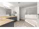 Bright bathroom featuring a garden tub, shower, and a vanity with storage at 8034 Sw 81St Loop, Ocala, FL 34476
