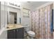 Cozy bathroom featuring a vanity with storage and a shower with patterned curtain at 8034 Sw 81St Loop, Ocala, FL 34476