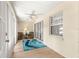 Inviting Florida room with neutral walls, ceiling fan, and sliding glass door to the backyard at 8034 Sw 81St Loop, Ocala, FL 34476