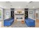 Community lounge area featuring blue sofas, decorative stone fireplace, and curated art pieces at 8034 Sw 81St Loop, Ocala, FL 34476