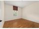 Neutral bedroom with laminate floors, a window with blinds, and base trim at 8611 Sw 83Rd Loop, Ocala, FL 34481