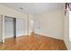Bedroom featuring laminate floors, a closet with sliding doors, and neutral walls at 8611 Sw 83Rd Loop, Ocala, FL 34481