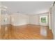 Bright and airy living room featuring hardwood floors, a large window, and ample space for entertaining at 8611 Sw 83Rd Loop, Ocala, FL 34481