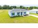 Beautiful single-story home featuring new construction, a manicured lawn, and a single-car garage at 87 Redwood Rd, Ocala, FL 34472