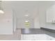 Modern kitchen with sleek white cabinets, dark countertops, and natural light offers modern comfort at 87 Redwood Rd, Ocala, FL 34472