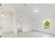Sun-drenched living room with a window view, featuring white walls, and light wood-look floors for a modern aesthetic at 87 Redwood Rd, Ocala, FL 34472