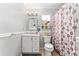 Bright bathroom with white vanity, decorative shower curtain, and ample lighting for a refreshing experience at 8940 Se 87Th Ter, Ocala, FL 34472