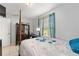 Comfortable bedroom with a four-poster bed, complemented by blue accents and a bright window at 8940 Se 87Th Ter, Ocala, FL 34472