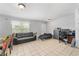 A well-lit living area featuring tile flooring and neutral wall paint at 8940 Se 87Th Ter, Ocala, FL 34472